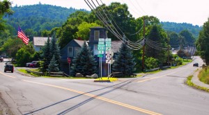 Maple Street to the left, Depot Street on the right with state route signs on an island. Click to enlarge. Photo by Cynthia Prairie.
