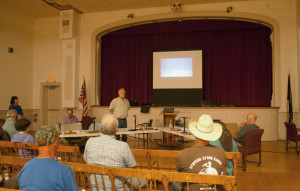 David Pisha gives a power point presentation on the water project. Engineer Naomi Johnson stands at tht far right.