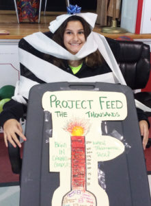 Student Eliza Burbela gets toilet-papered upon completion of the CAES food drive.