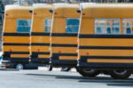 One adult, no students injured in early morning car-bus accident