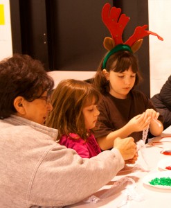 From left, Barbara Mello and granddaughter Lindsey, with Zoey create lace and bead candy canes at one of many crafts tables at Chester-Andover Elementary School.