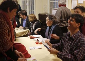 Signing books and speaking with audience members are seated, from far right: Dr. Eben Alexander; Carole DeSanti; Kathy Shields and Kieren Shields. Lynne Reed, co-owner of the bookstore, is standing behind Alexander. Photo courtesy Malcolm Moore.