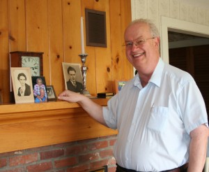 Galen Pinkham, Jean and George Winston's nephew, at the mantelpiece of the Winston home, a picture of a young Jean Winston stands on the far left./Photos by Cynthia Prairie