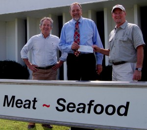 From left, Black River Produce owners, Mark Curran and Steve Birge flank Larry Kraft of Springfield Hospital in this photo op check presentation in front of Black River Produce in Springfield.
