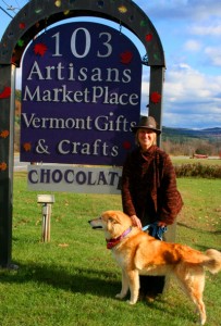 Elise Junker and Mia at the new sign for the former Gallery 103. Photo by Cynthia Prairie