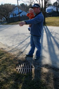 Jake Arace stands above the drain that leads to the dry well below. His home is to the left.