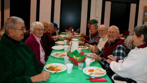 Clockwise from left, George and Cheryl Cook, Norman Wright, Ruth Harrison, Ann Curran, Chris Curran, Marcia Clinton, Norm Harrison, Jack Cable and Beverly Cable enjoy their Christmas dinner and each other's company.