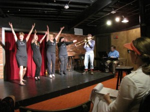Actor Susan Haefner, seated right, observes students performing during a class. Photo provided.