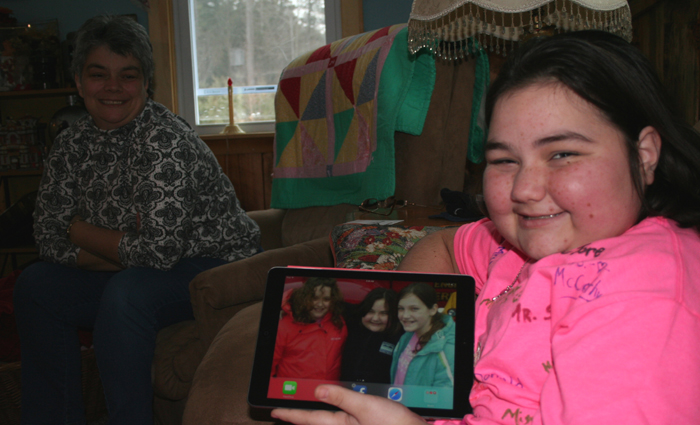 As Sue looks on, Lindsey holds up her new IPad given to her by members of the Chester Fire Department so that she can Skype with school and friends while she undergoes treatment and a bone marrow transplant. Her IPad bears the photo of Meekah Hance with Lindsey and Madison Wilson.