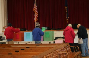 Voters in Chester match the paper ballots with the boxes as Ken Barrett helps with the electronic vote tally machine.