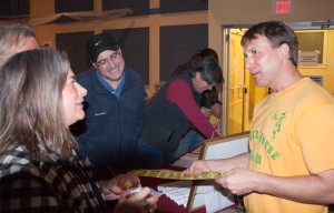 Sam Gordon, in a yellow and very well preserved Pioneer House T-shirt, greets guests at Friday's fund-raiser. Photos by Shawn Cunningham.