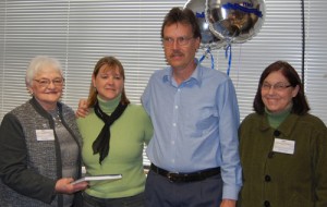 Anne Miller and Nancy Lanoue, authors of "100 Years of Caring - A History of Springfield Hospital," present a copy to Chris and Dan Chapman, center. Chapman is the great nephew of one of the founders of the hospital, Dr. Bertrand Chapman. Photo provided.