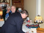 Barb Westine, Brian Morris and Steven Davis peruse the silent auction table. 