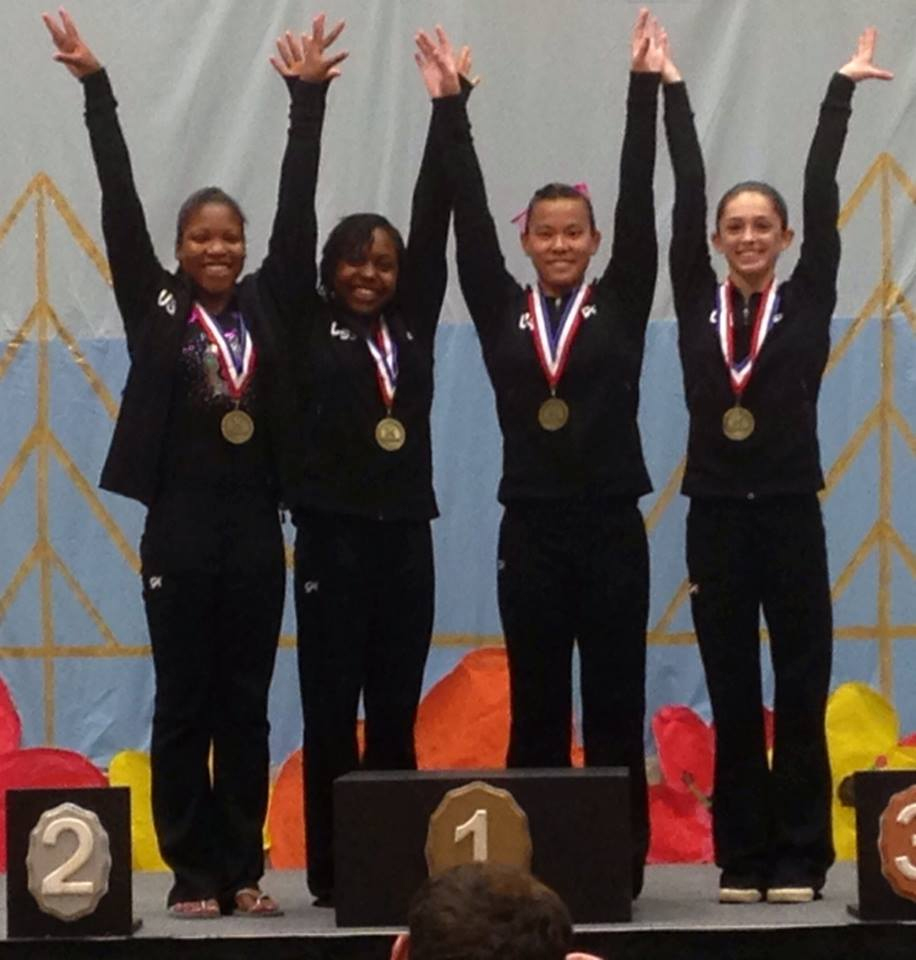 Maci Prescott, 2nd from left, stands on the winners podium with other gymnasts.