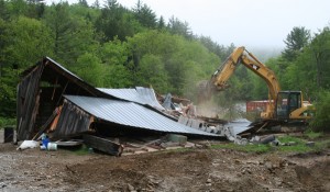 Around 7:40 a.m. Wednesday, May 28, crews tear down the Brookeses' garage to begin digging up contaminated dirt beneath.