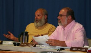 Select Board member Derek Suursoo, left, explains his disdain for contracts as member Bill Lindsay listens.