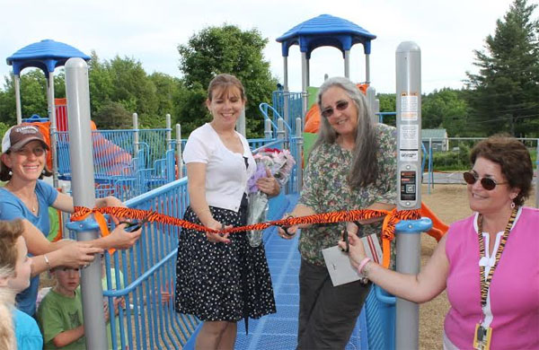 From left, Jennie Freeman, Jackie Wiley, Karol Allen and Karen MacAllister get ready to cut the ribbon of the Flood Brook playground. Photo provided.