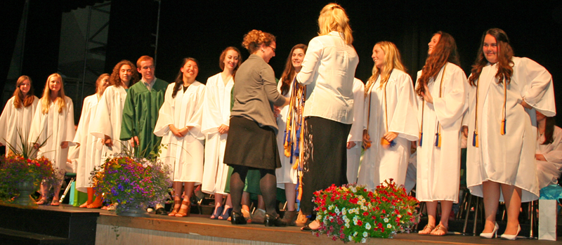 Pam O'Neal and Ally Oswald present members of the National Honor Society with their cords.