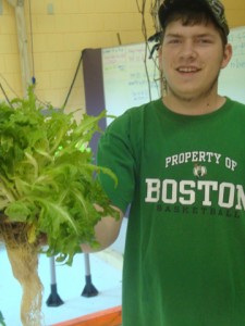 Andrew Plumb proudly displays a healthy root system of a lettuce plant.
