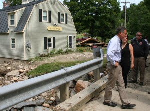 Gov. Shumlin looks over the damage on Kingsbury Road, where the Defoe house foundation was left exposed from high waters.