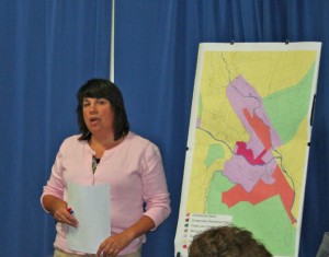 Planning Commission member and engineer Naomi Johnson shows the crowd the map outlining the new allowance for gas stations, and auto service and sales on Main Street south. Photos by Cynthia Prairie