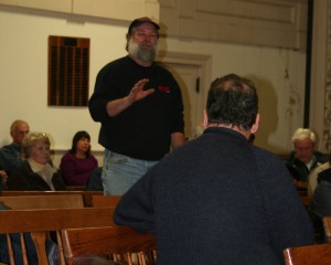 Auto service station owner Roy Spaulding speaks directly with architect Claudio Veliz.