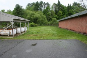 A state agency has recommended using the second drive, foreground, as egress for the Armory. But the new owner says a drive would run over its septic field, in background. Telegraph photo.