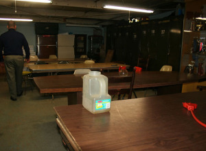 A plastic container, foreground, and a coffee urn are just two of the containers that the department uses to catch water dripping from the roof to the 2nd floor lounge.