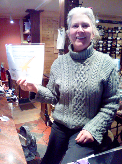 Leslie Stuart of the Wine and Cheese Depot with her certificate of recognition.