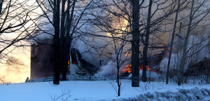 At 6:55 a.m., flames could be seen at the ground level of the Monier home on Elm Street in Chester. Claudio Veliz photo.