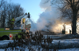 Firefighters from Ludlow help put out last Friday's fire at Elm Street in Chester. Photo by Shawn Cunningham.