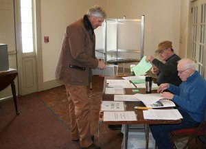 A voter checks in Tuesday morning at the Weston Playhouse. Photos by Shawn Cunningham. Click any photo to launch the gallery.