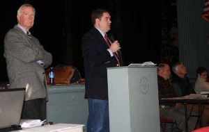 Moderator Wayne Granquist listens intently as state Rep. Oliver Olssen speaks to Weston voters.