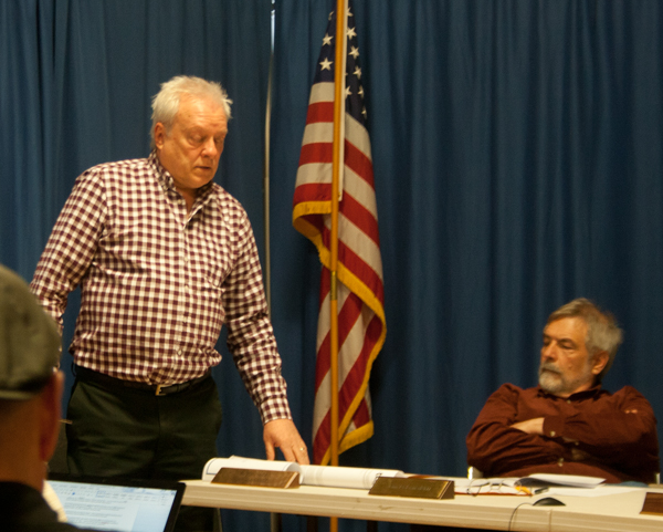 Town manager David Pisha, standing, explains the project as Select Board chair John DeBenedetti listens.