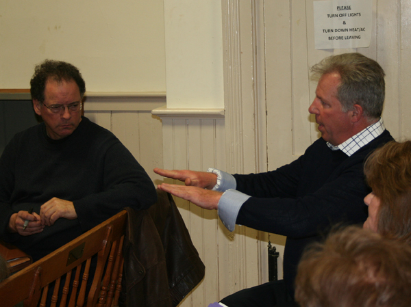 Ronald Keith, right, speaks about vault shelving as Claudio Veliz listens.