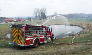 Chester's Engine One draws water from a pond while relieving excess pressure back into the pond.