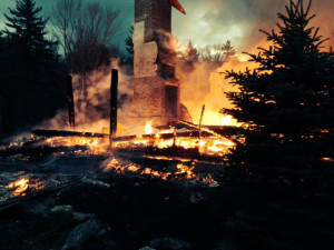 Just two chimneys were left standing  as firefighters turned to a rapidly spreading grassfire. 