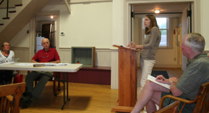 Jennie Auster, at the podium, addresses wastewater regulations.