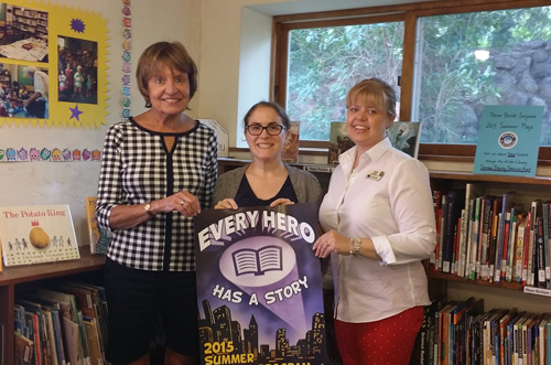 Connie Rogers and Ann Warrell from the Vermont Country Store's Community Action Team congratulate Kerri MacLaury, Wilder Library Director (center).