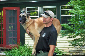 State Police Search and Rescue team members Joseph Duca and Buck take a break from the search on Friday. Photo by Shawn Cunningham