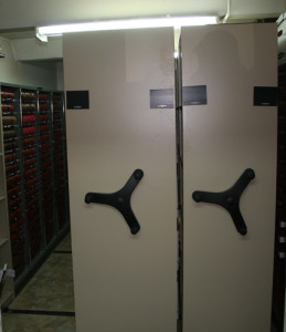 Two double-sided moveable shelves installed. Turning the handle of  one unit moves it sideways and creates a new aisle.