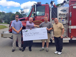 From left, Ben Whalen, firefighter and head of Yosemite Engine, One Credit Union president Jerry Cross, Chester Fire Department Chief Matt Wilson, and Michael Graham, branch manager of the Chester One office. Photo by Taylor Wilson.