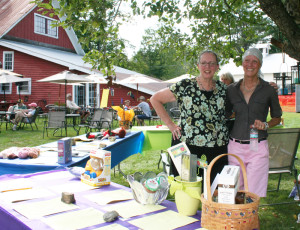 Sherry Willumitis and Stephanie Mahoney of the Chester-Andover Family Center get a shady spot to man the silent auction booth.
