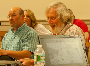 Matt Wamsganz of Champlain Oil, left, listens as architectural historian Hugh Henry testifies about saving the house on the proposed Jiffy Mart site.