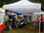 Suzanne Lawler of Six Loose Ladies, far left, attracts attention on the converted stationery bike, which now aids in spinning wool, if not exercise.