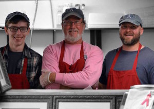 From left, Bruce Johnson, Lonnie Lisai and Andrew Lisai at the deli counter ready to make some bulkies. Photo from Facebook page