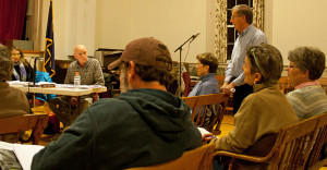 Stephen Davis stands to address the information booth situation.