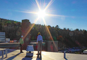 Mark Blanchard, Director of Engineering, and Larry Kraft, Director of Development, survey the future site of a solar hot water project on the roof at Springfield Hospital.