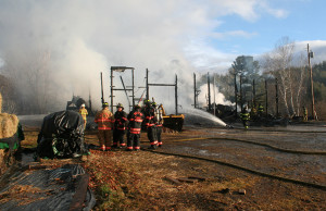 Firefighters from several departments work the barn fire Friday morning