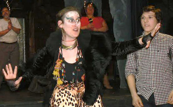 The Greek god Pan (Monica Lauritsen) leads a group of woodland creatures to celebrate the union of Shelley (Allie McGahie) and Bat Boy/Edgar (Liam Johnson) in a scene from Bat Boy: The Musical at Main Street Arts.